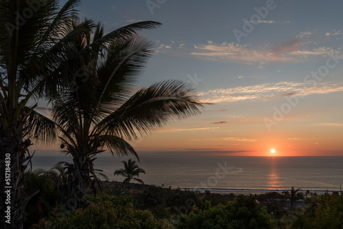 Beautiful, tropical sunset at La Reunion, sun over the sea with orange sky