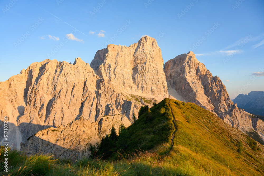 Stunning view of a person enjoying the view of Monte Pelmo from the summit of Col de la Puina. Monte Pelmo was the very first high mountain of the Dolomites that was climbed, Italy.