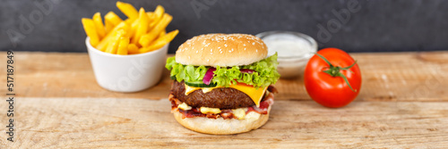 Hamburger Cheeseburger meal fastfood fast food with French Fries on a wooden board panorama © Markus Mainka