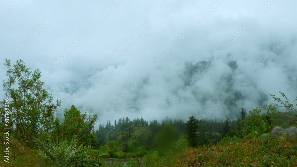 Timelapse of monsoon clouds over  green mountains and raining during monsoon at Manali in Himachal Pradesh, India. Clouds time-lapse of the Himalayan mountain range. Ken Burn effect timelapse.