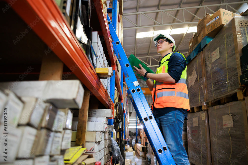 © NVB Stocker - Portrait handsome Asian male warehouse professional worker in safety vest and hardhat helmet in warehouse factory industrial. product in cardboard boxes on stored shelves. © NVB Stocker - Portrait handsome Asian male warehouse professional worker in safety vest and hardhat helmet in warehouse factory industrial. product in cardboard boxes on stored shelves.