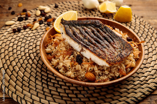 SAYADIYAH or SAYADIEH served in a dish isolated on wooden background side view photo