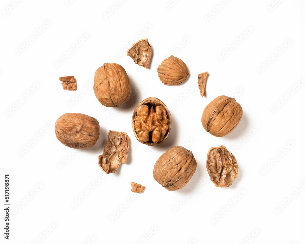 Whole walnut on white. Half Walnut isolate. Full depth of field. pieces of shell. Whole walnut on white. Half Walnut isolate. Full depth of field. pieces of shell.
