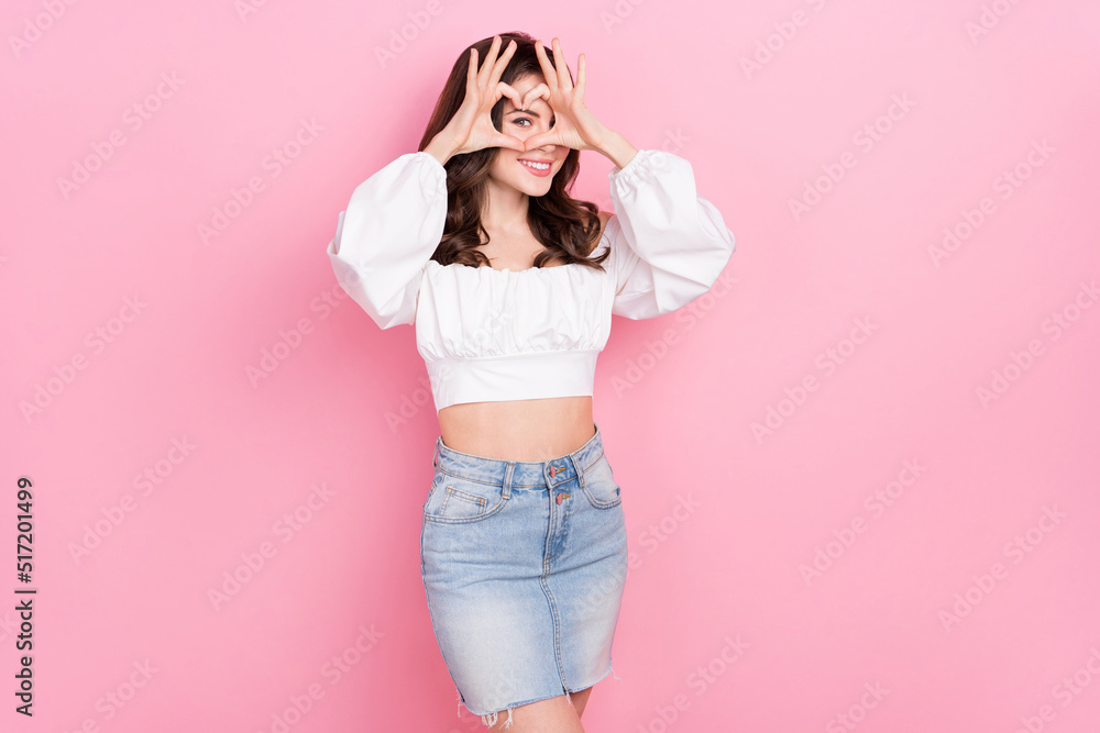 Photo of charming attractive female showing heart symbol express her feelings isolated on pink color background Photo of charming attractive female showing heart symbol express her feelings isolated on pink color background