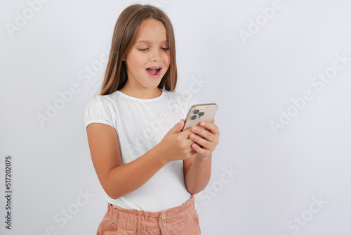 the girl is surprised and looks at the phone. High quality photo