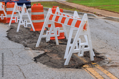 Road potholes damaged in the pavement need to be repaired with a carriageway bypassing the area