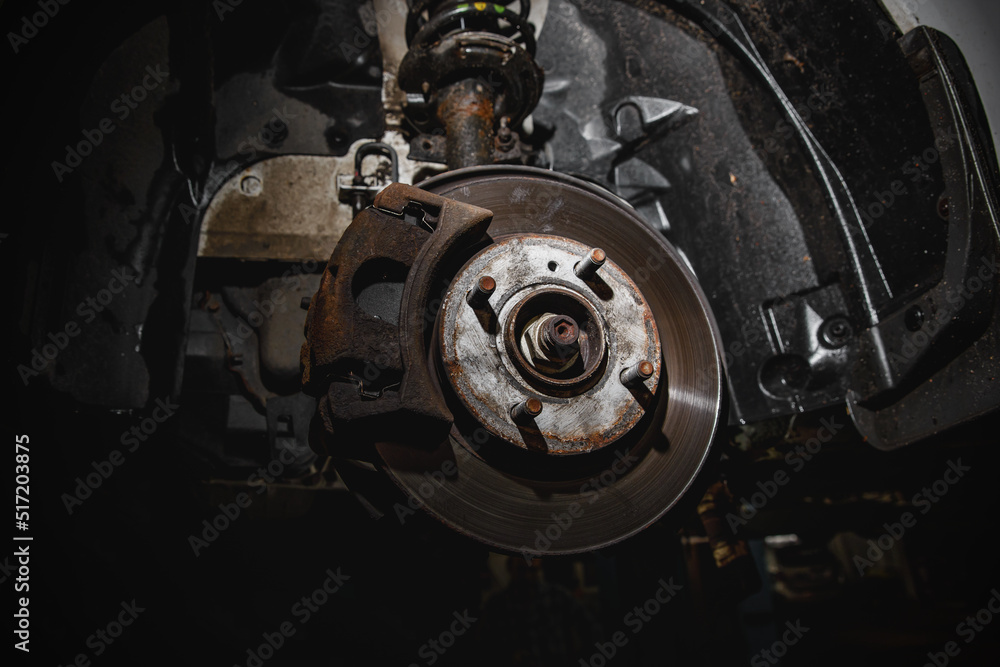 Disc and brake caliper of the vehicle for repair in the garage Disc and brake caliper of the vehicle for repair in the garage