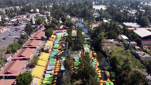 An aerial drone shot of colorful boats in Xochimilco. Tours by cannels with floating gardens in Mexico City CDMX, Mexico photo