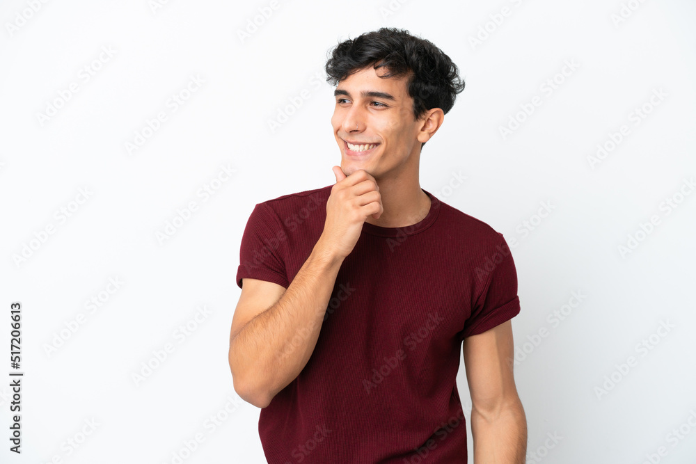 Young Argentinian man isolated on white background looking to the side and smiling Young Argentinian man isolated on white background looking to the side and smiling