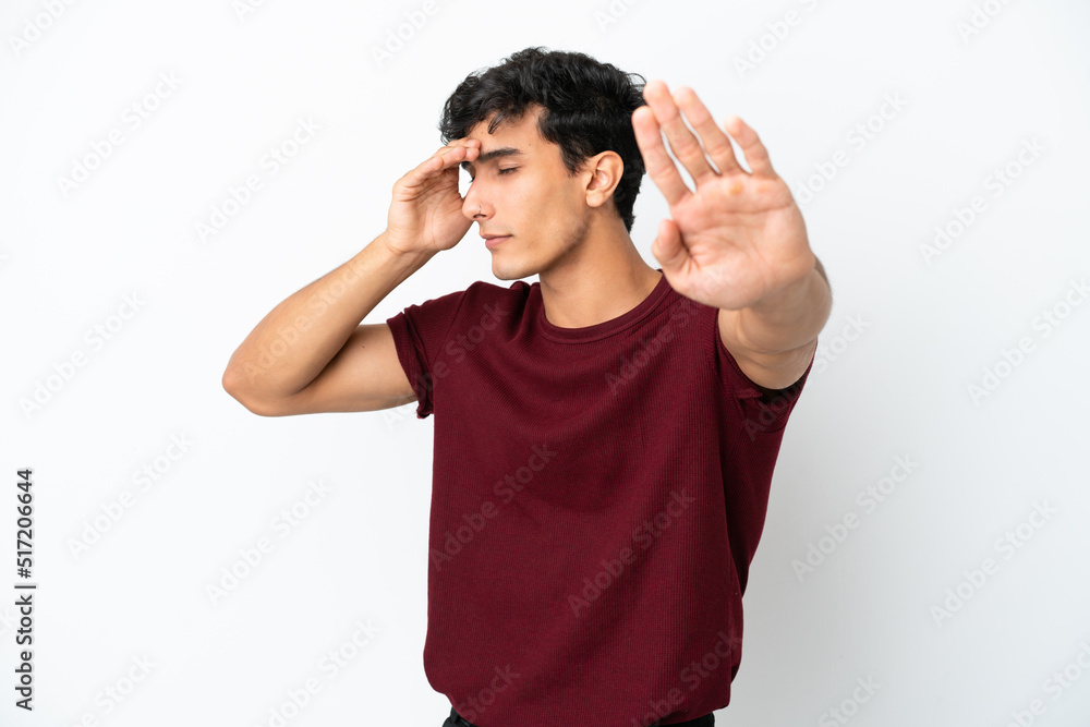 Young Argentinian man isolated on white background making stop gesture and covering face Young Argentinian man isolated on white background making stop gesture and covering face