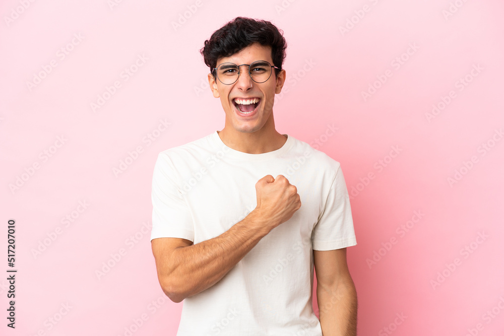 Young Argentinian man isolated on pink background celebrating a victory Young Argentinian man isolated on pink background celebrating a victory
