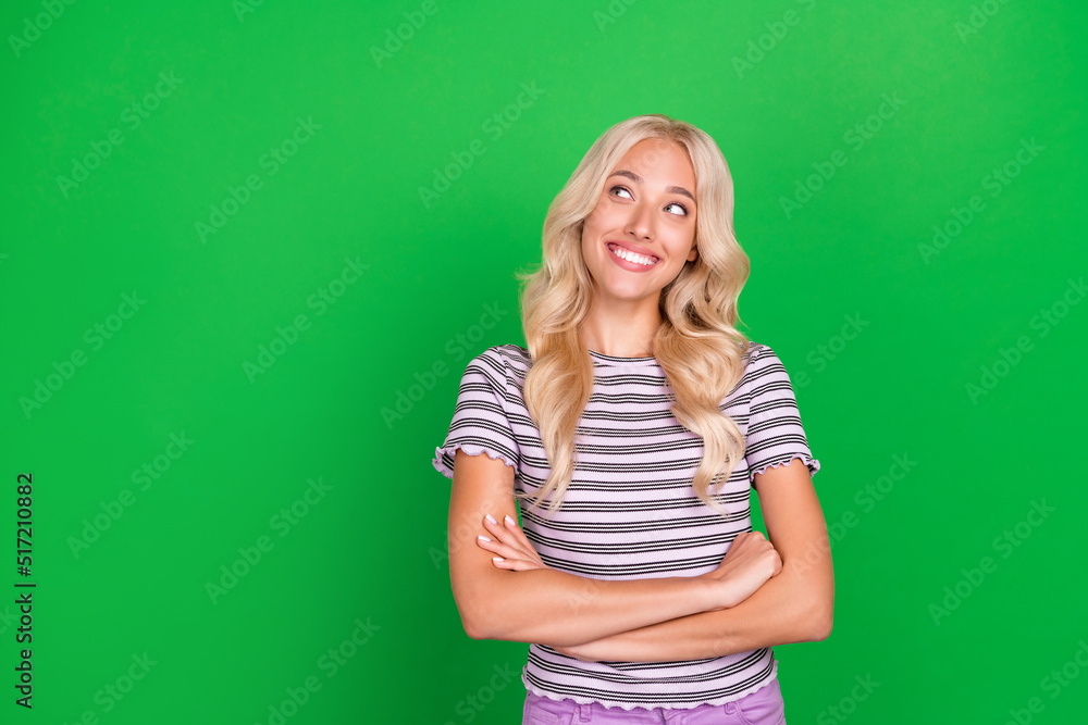 Portrait of pretty cheerful minded person folded hands look empty space isolated on green color background Portrait of pretty cheerful minded person folded hands look empty space isolated on green color background