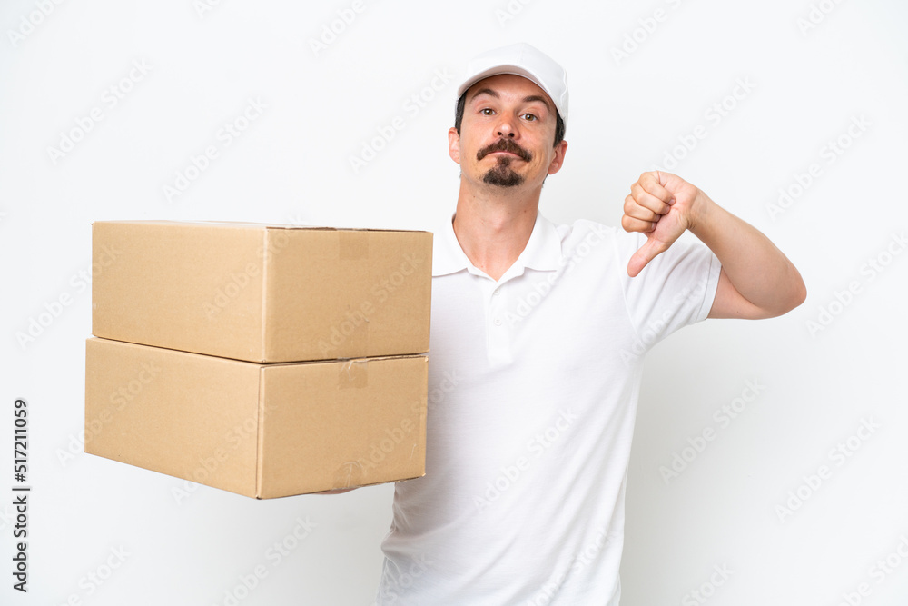 Delivery caucasian man isolated on white background showing thumb down with negative expression Delivery caucasian man isolated on white background showing thumb down with negative expression
