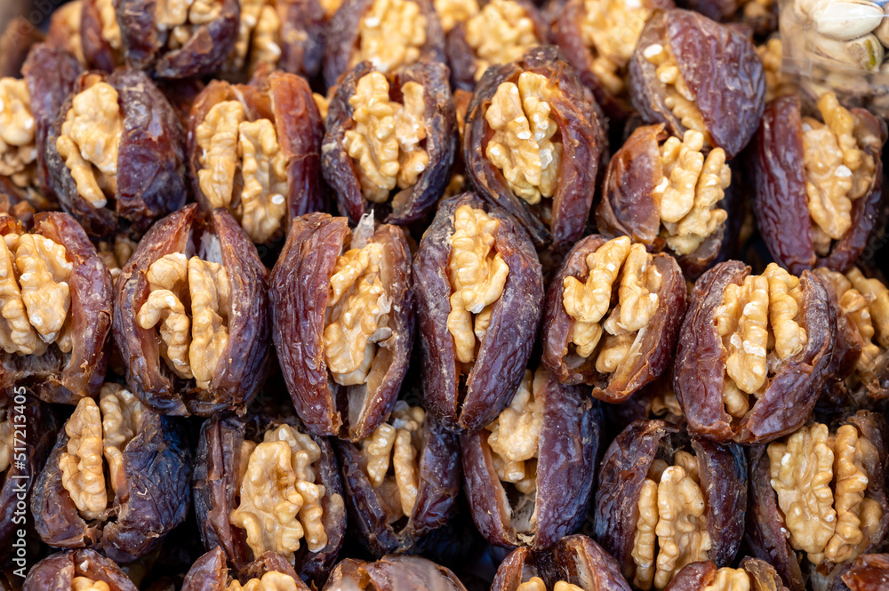 Turkish or arabic sweet dessert, ripe dried dadels with walnuts sweetened with syrup or honey. Turkish or arabic sweet dessert, ripe dried dadels with walnuts sweetened with syrup or honey.