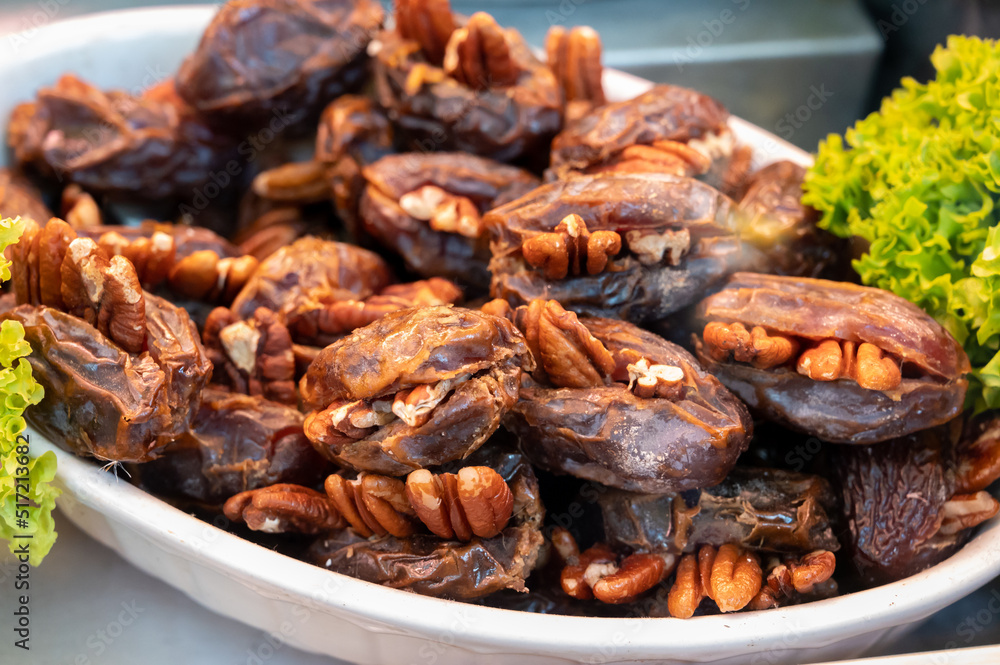 Turkish or arabic sweet dessert, ripe dried dadels with walnuts sweetened with syrup or honey. Turkish or arabic sweet dessert, ripe dried dadels with walnuts sweetened with syrup or honey.