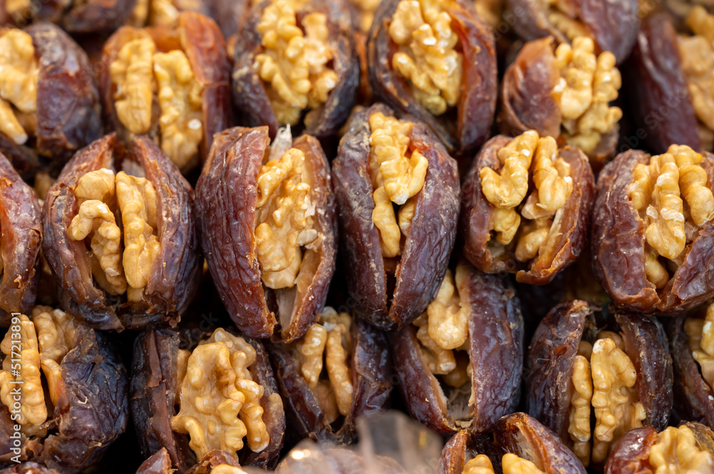 Turkish or arabic sweet dessert, ripe dried dadels with walnuts sweetened with syrup or honey. Turkish or arabic sweet dessert, ripe dried dadels with walnuts sweetened with syrup or honey.