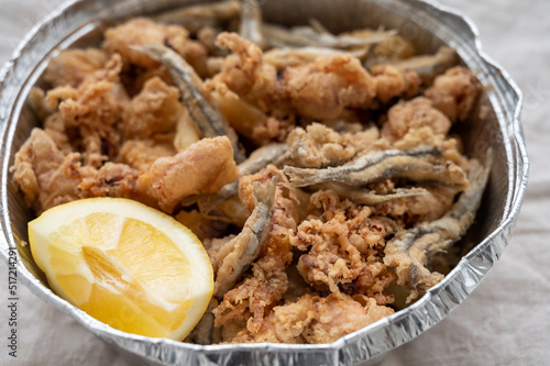 Spanish sea food, cripsy deep fried baby octopus, fish, calamari rings served with lemon photo