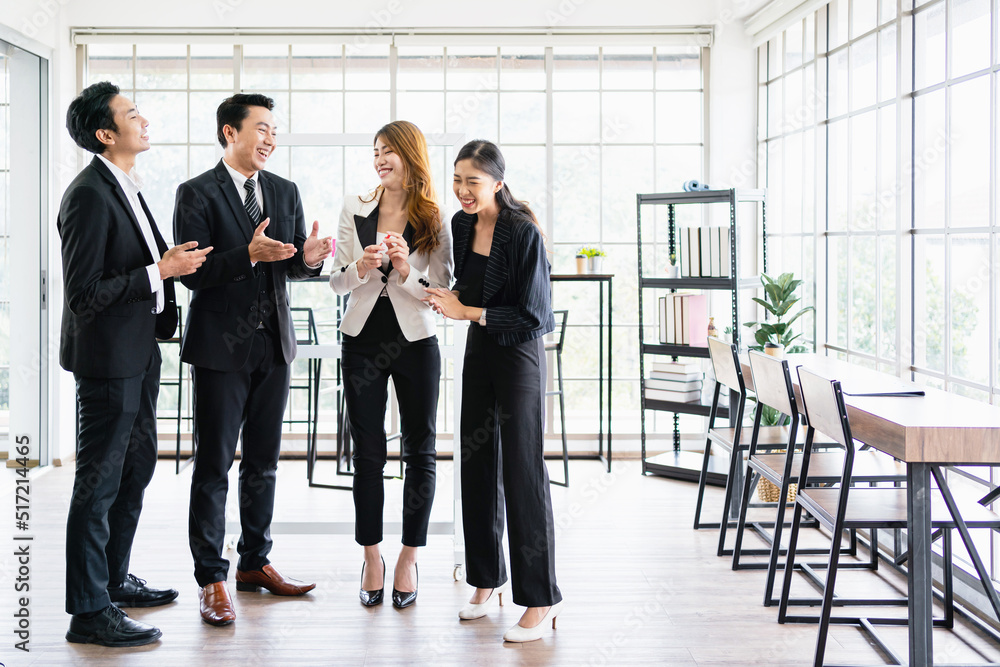 A group of male and female Asian businessmen colleagues smiling and standing happily together for a successful project. Unity and diversity of position executive, manager and employee teamwork concept A group of male and female Asian businessmen colleagues smiling and standing happily together for a successful project. Unity and diversity of position executive, manager and employee teamwork concept
