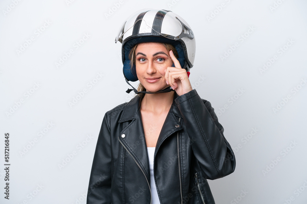 Young caucasian woman with a motorcycle helmet isolated on white background thinking an idea Young caucasian woman with a motorcycle helmet isolated on white background thinking an idea