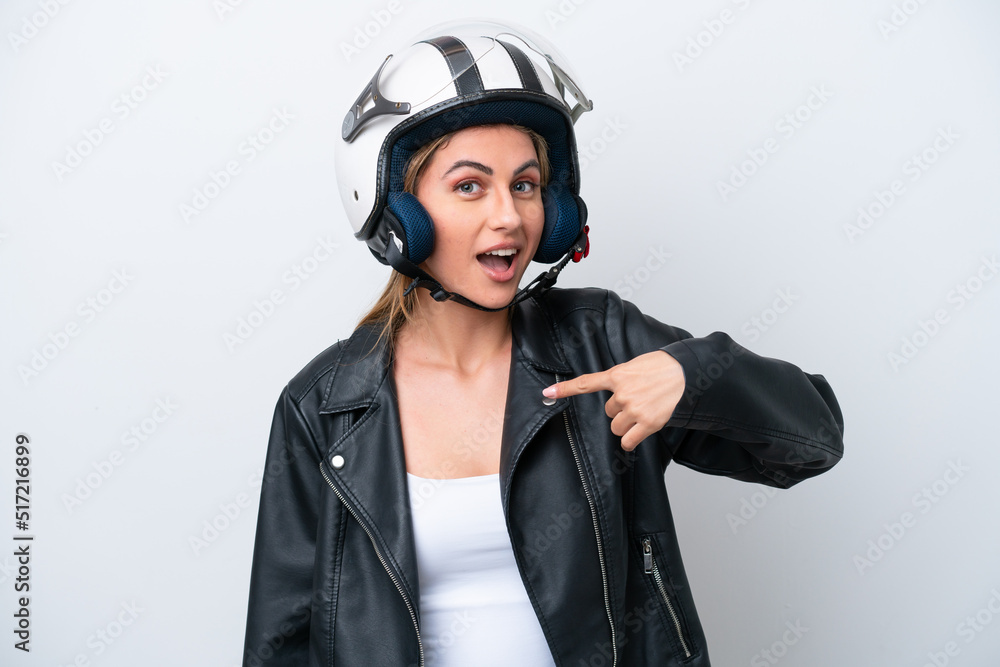 Young caucasian woman with a motorcycle helmet isolated on white background with surprise facial expression Young caucasian woman with a motorcycle helmet isolated on white background with surprise facial expression
