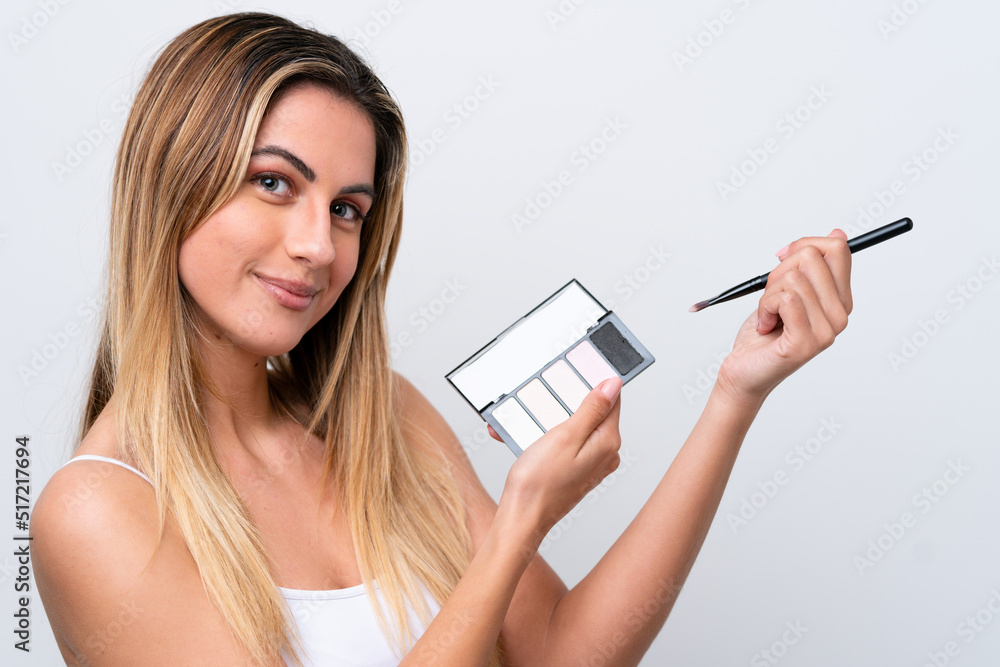 Young caucasian woman isolated on white background with makeup palette Young caucasian woman isolated on white background with makeup palette