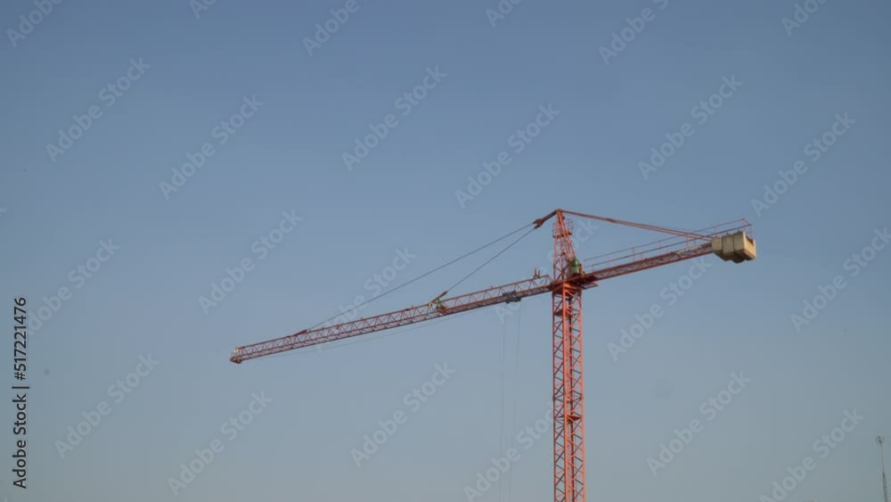red crane on blue sky spinning at dawn. 4k horizontal video red crane on blue sky spinning at dawn. 4k horizontal video