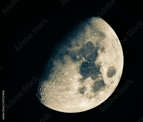 Waxing gibbous moon over dark sky at night