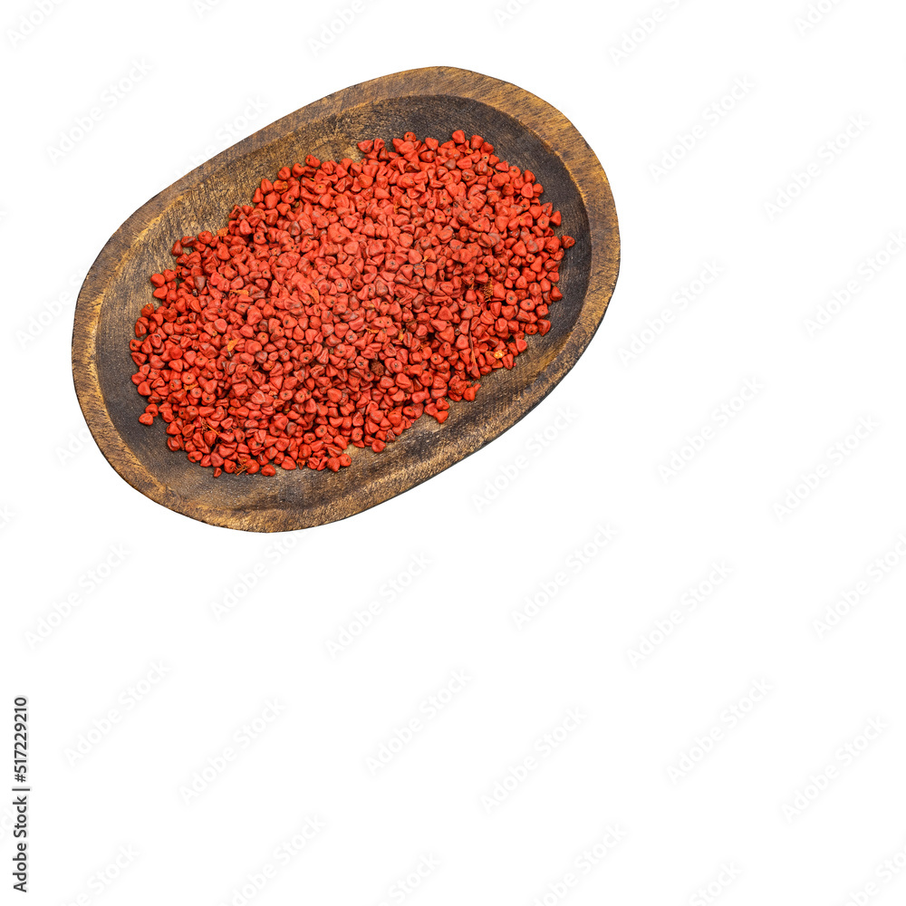 Bixa Orellana - annatto organic seeds in the wooden bowl Bixa Orellana - annatto organic seeds in the wooden bowl