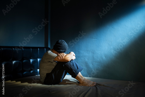 sad man in the dark room photo