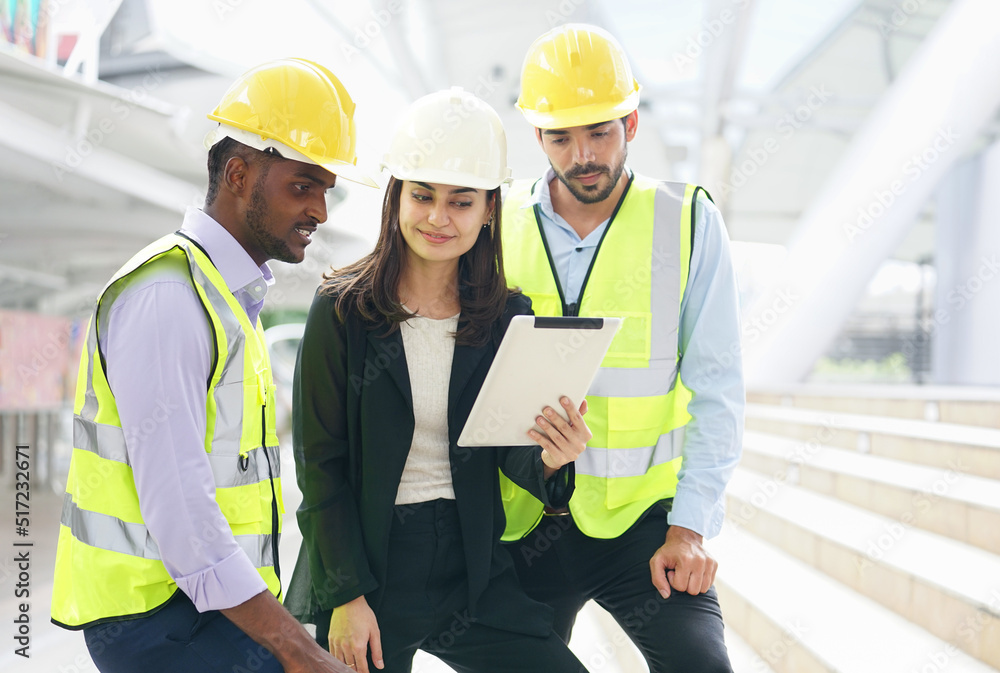 engineers team are discussing while inspecting at construction site, multiracial business engineering man and woman are working outdoors in the urban engineers team are discussing while inspecting at construction site, multiracial business engineering man and woman are working outdoors in the urban