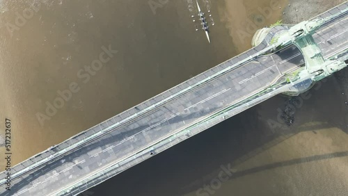 Aerial top view of rowers passing under Hammersmith Bridge in London, UK photo