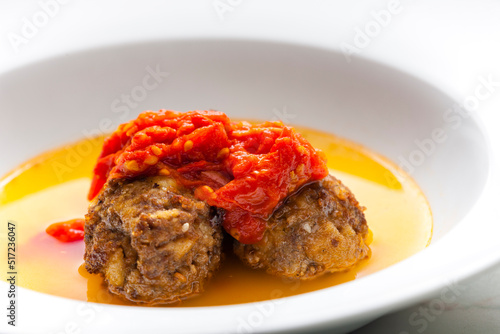 broth with meatballs and tomato sauce photo