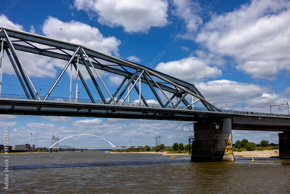 Obraz premium Detail of Snelbinder bridge seen from the water. River Maas waterfront shore of historic Hanseatic city Nijmegen