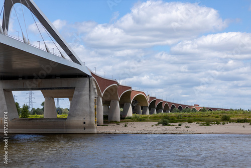 De Oversteek bridge seen from the water. River Maas waterfront shore of historic Hanseatic city Nijmegen photo