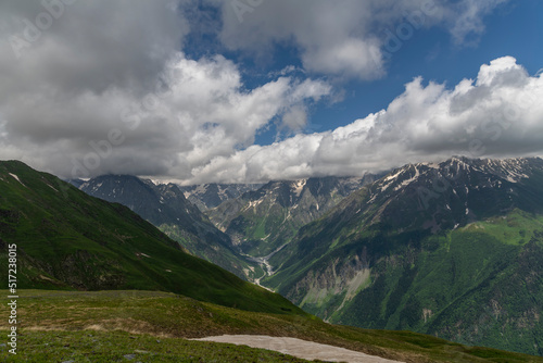 Fototapeta Naklejka Na Ścianę i Meble -  Clouds over the mountains and green hills.