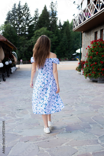 the girl walks in the summer in a light dress © Міша Мула