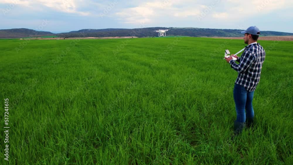 Modern Technologies in Agriculture. Farmer flying a drone over a young wheat field. High quality 4k footage Modern Technologies in Agriculture. Farmer flying a drone over a young wheat field. High quality 4k footage