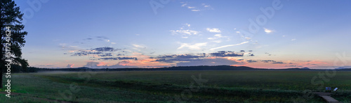 Panorama of a sunset over a mountain meadow
