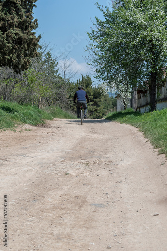 Wallpaper Mural A man riding a bicycle on the driveway in the park. Torontodigital.ca