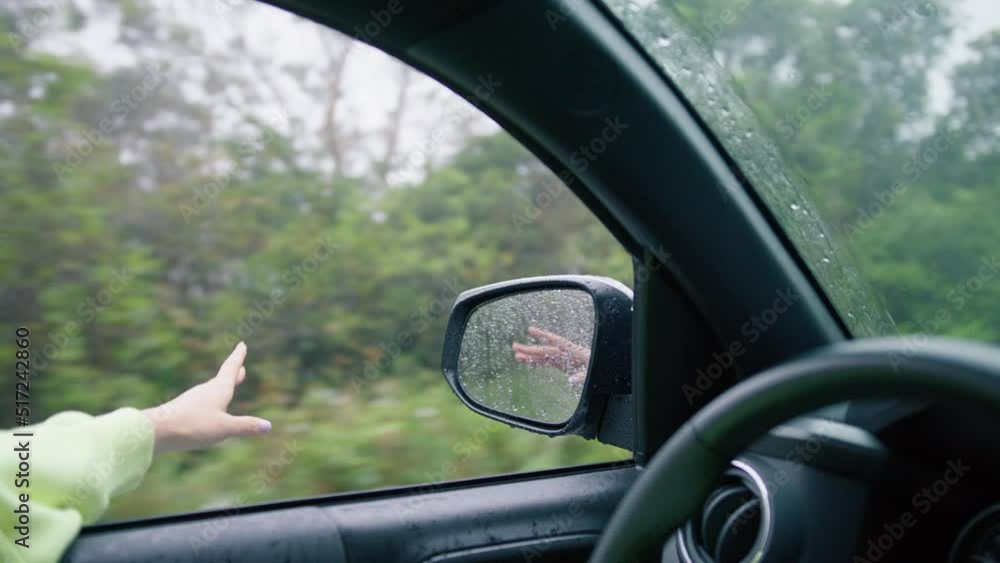 custom made wallpaper toronto digitalFemale hand catching rain drops while driving in forest. Happy girl in car window. Girl travels by car. Hand stretched in wind under rain. Windy rain from car window. Happy girl waving from car window