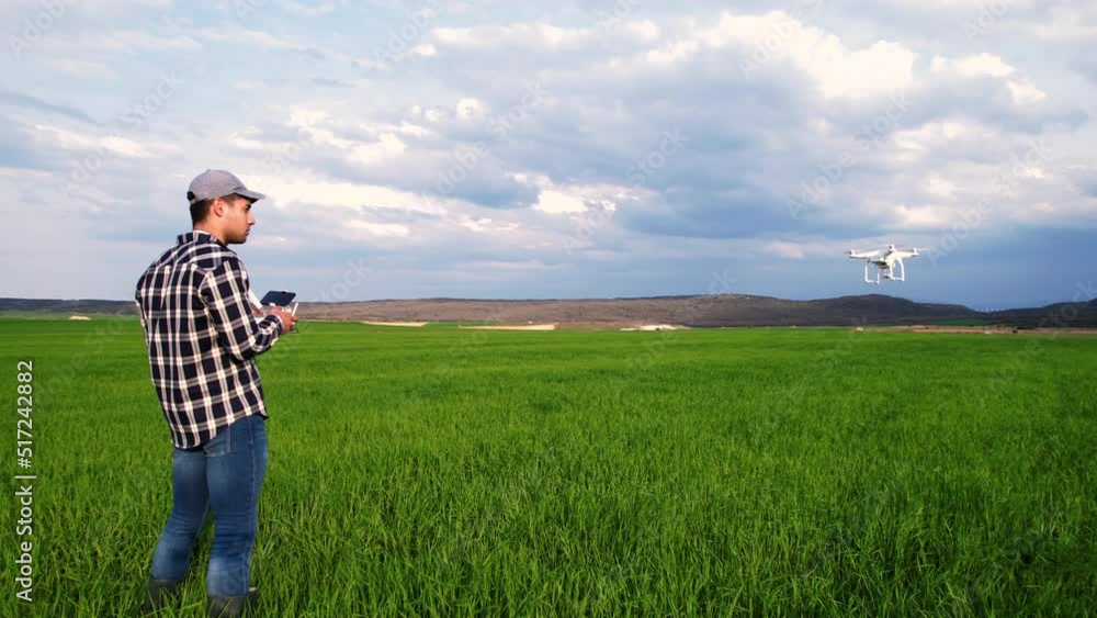 Modern Technologies in Agriculture. Farmer flying a drone over a young wheat field. High quality 4k footage Modern Technologies in Agriculture. Farmer flying a drone over a young wheat field. High quality 4k footage