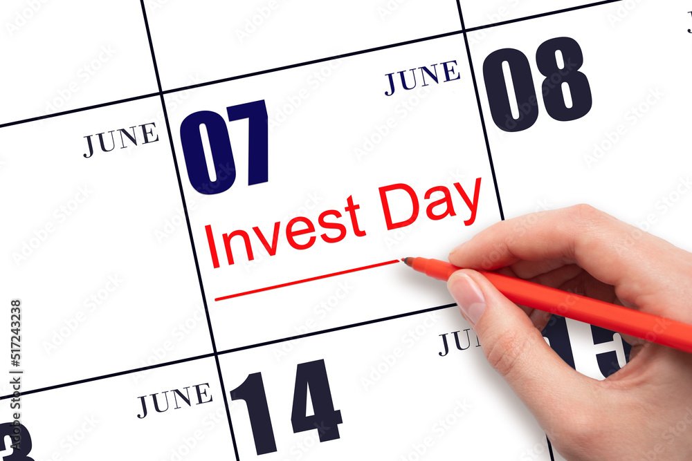 Hand drawing red line and writing the text Invest Day on calendar date June 7. Business and financial concept. Hand drawing red line and writing the text Invest Day on calendar date June 7. Business and financial concept.