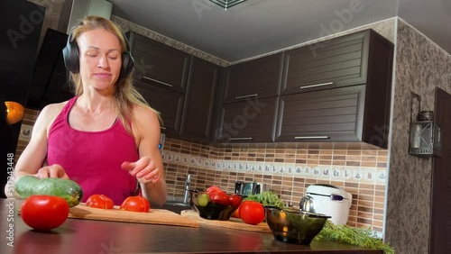 girl cutting salad in the kitchen