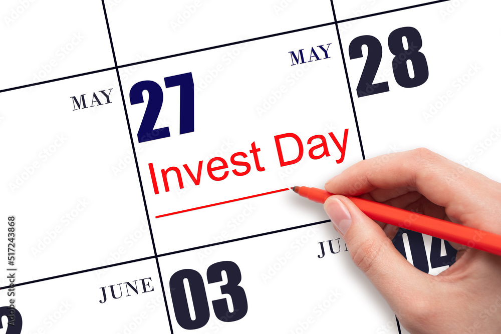 Hand drawing red line and writing the text Invest Day on calendar date May 27. Business and financial concept. Hand drawing red line and writing the text Invest Day on calendar date May 27. Business and financial concept.