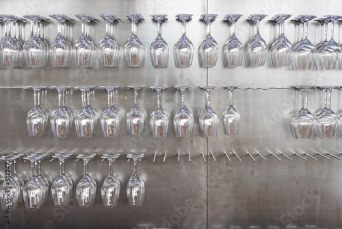 Wine glasses hanging on wall in wine shop