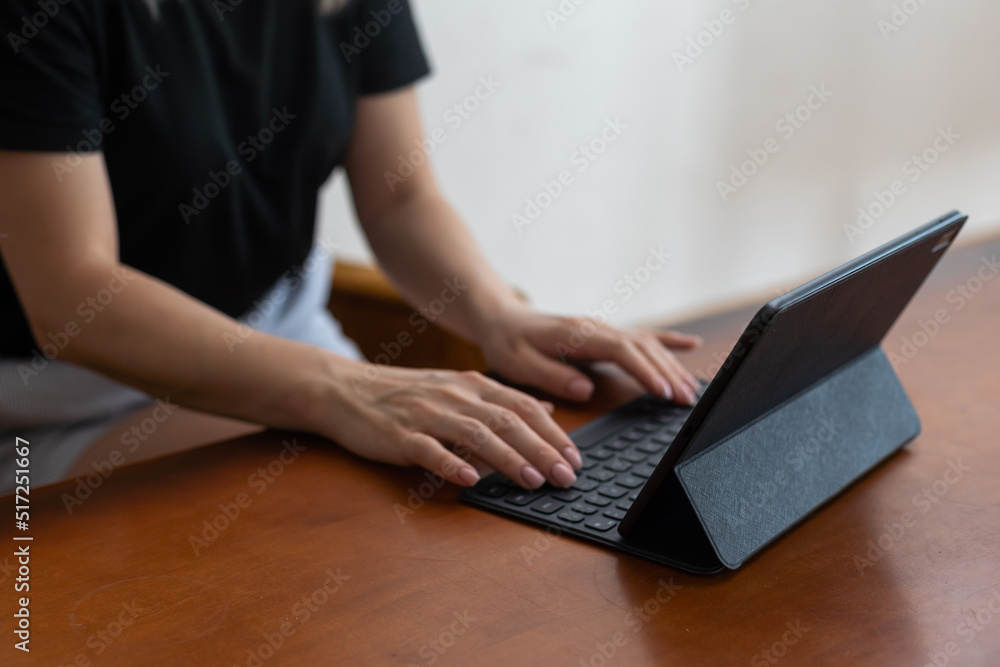 Young woman holding the tablet and sitting at home. Young woman holding the tablet and sitting at home.