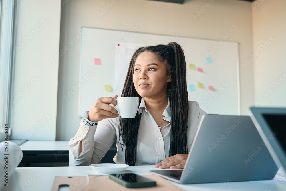 Pensive female architect seated at office table Pensive female architect seated at office table
