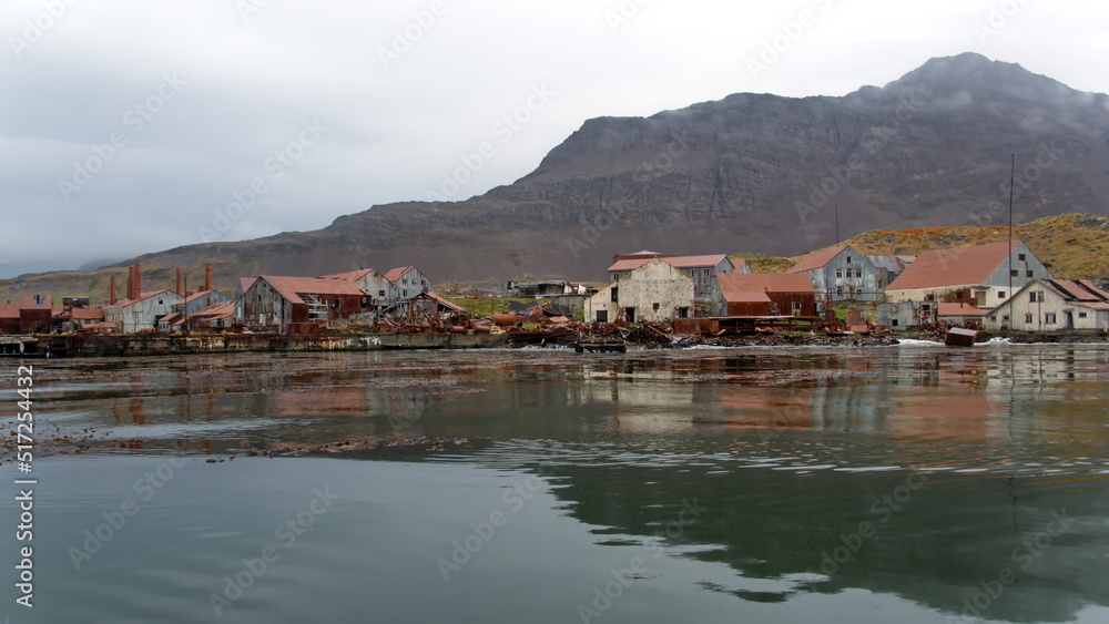 Rusted remains of a whaling station at Leith Harbor, South Georgia Island, under overcast skies Rusted remains of a whaling station at Leith Harbor, South Georgia Island, under overcast skies
