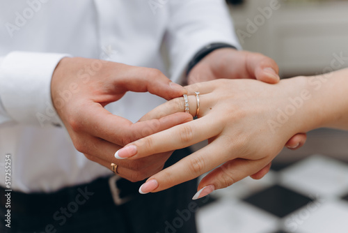 wedding rings on hands © Vadim_Bits
