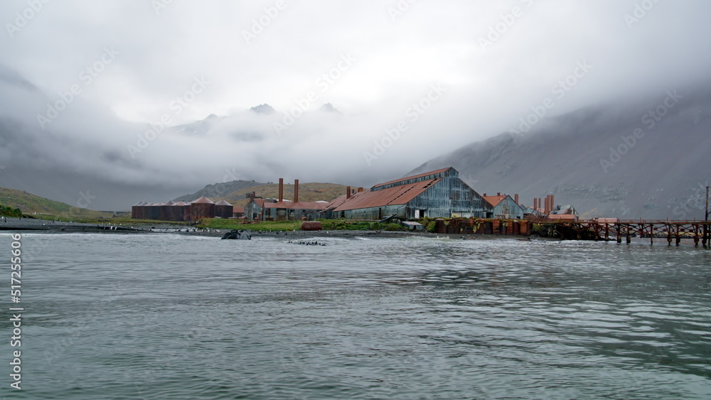 Rusted remains of a whaling station at Leith Harbor, South Georgia Island, under overcast skies